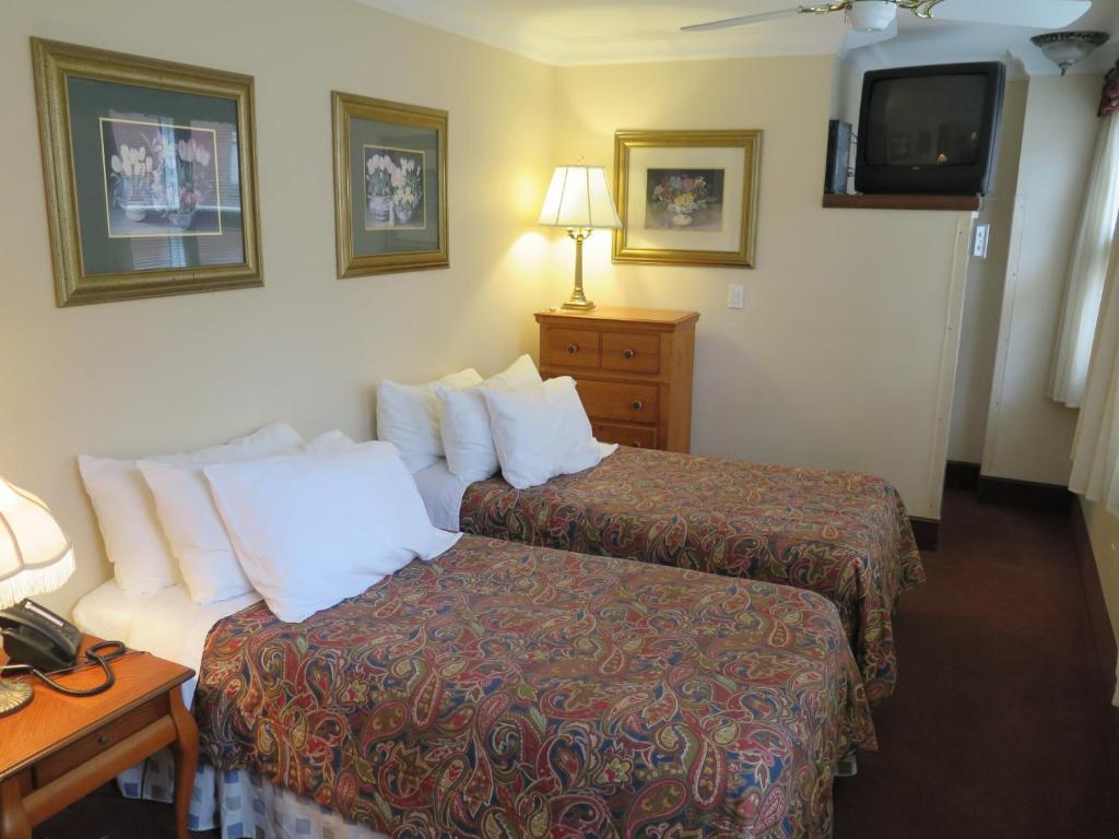 Postel nebo postele na pokoji v ubytování Madison Manor Boutique Hotel