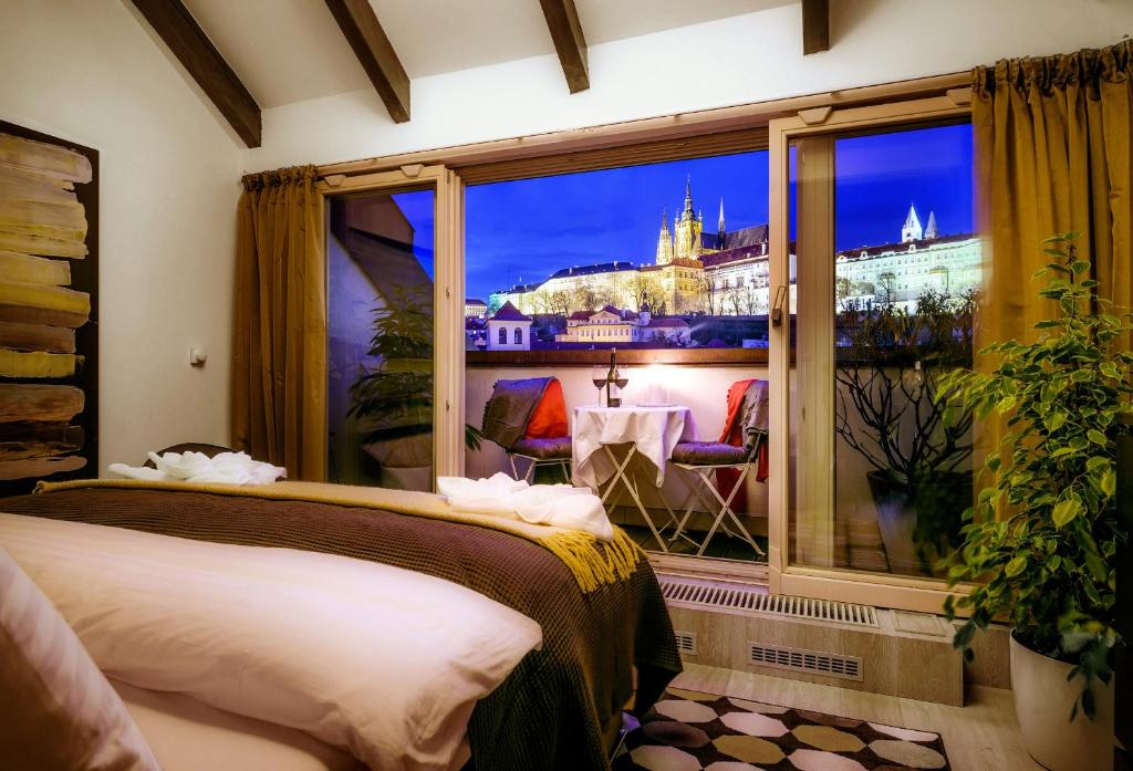 a room with two beds and a window with a view at President APT by Prague Castle, VIEWS in Prague