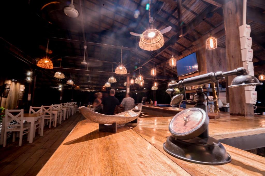 a bar with a counter with a clock on it at Sara Resort in Koh Rong Sanloem
