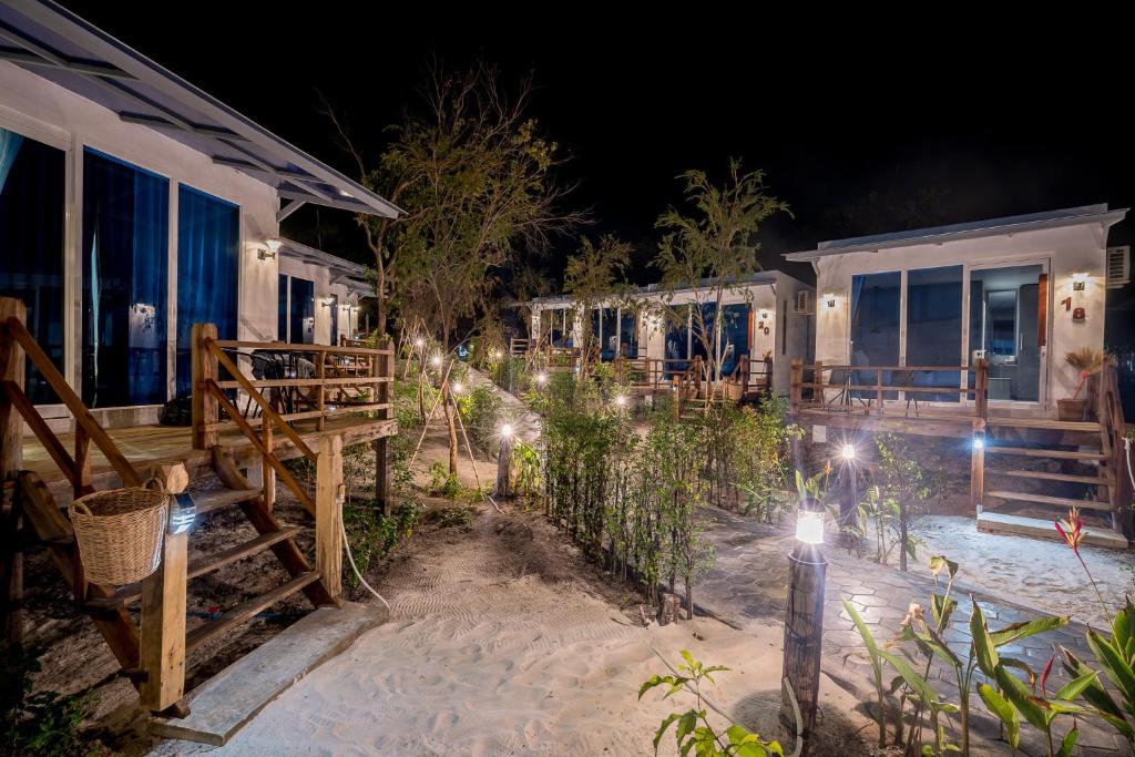 a row of houses on the beach at night at Sara Resort in Koh Rong Sanloem