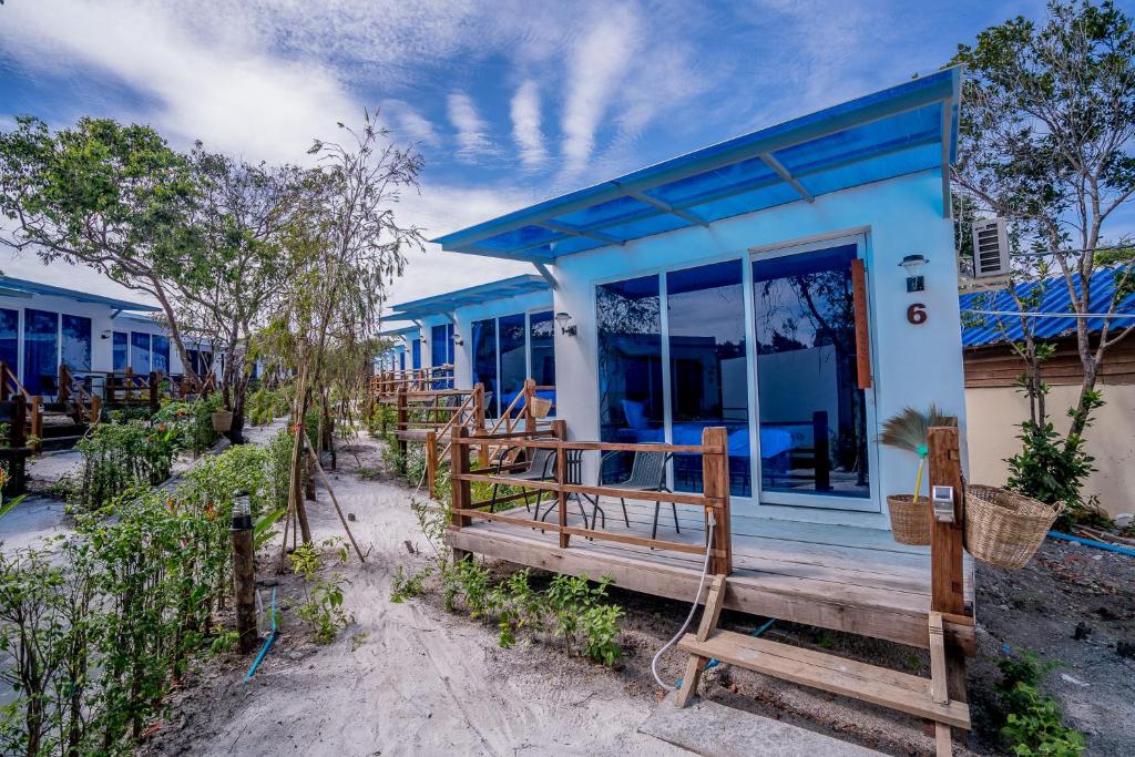 a blue house with a bench in front of it at Sara Resort in Koh Rong Sanloem