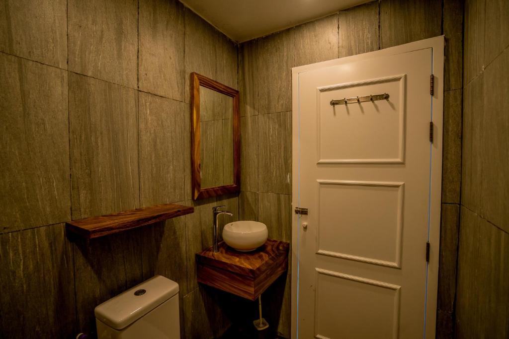 a bathroom with a toilet and a white door at Sara Resort in Koh Rong Sanloem