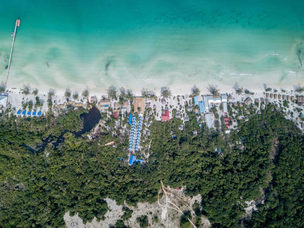 an aerial view of a beach with trees and buildings at Sara Resort in Koh Rong Sanloem