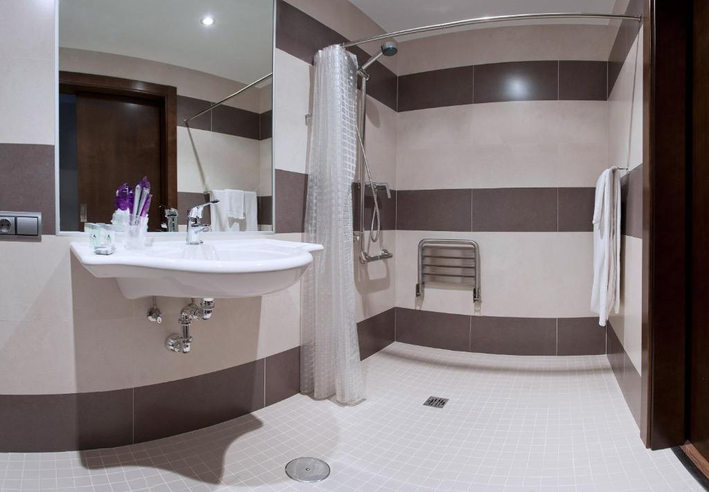 a bathroom with a sink and a shower at Hotel Río Hortega in Valladolid