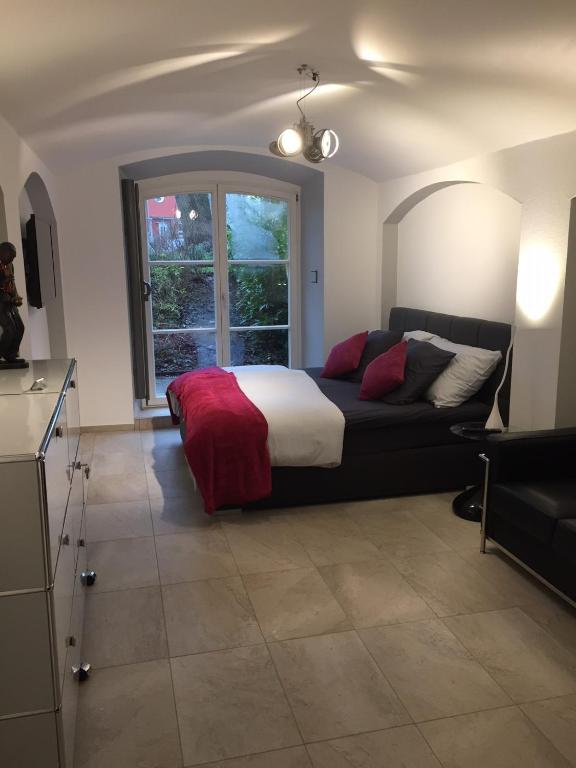 a bedroom with a bed and a couch and a window at Schlosspark Residenz in Schwerin
