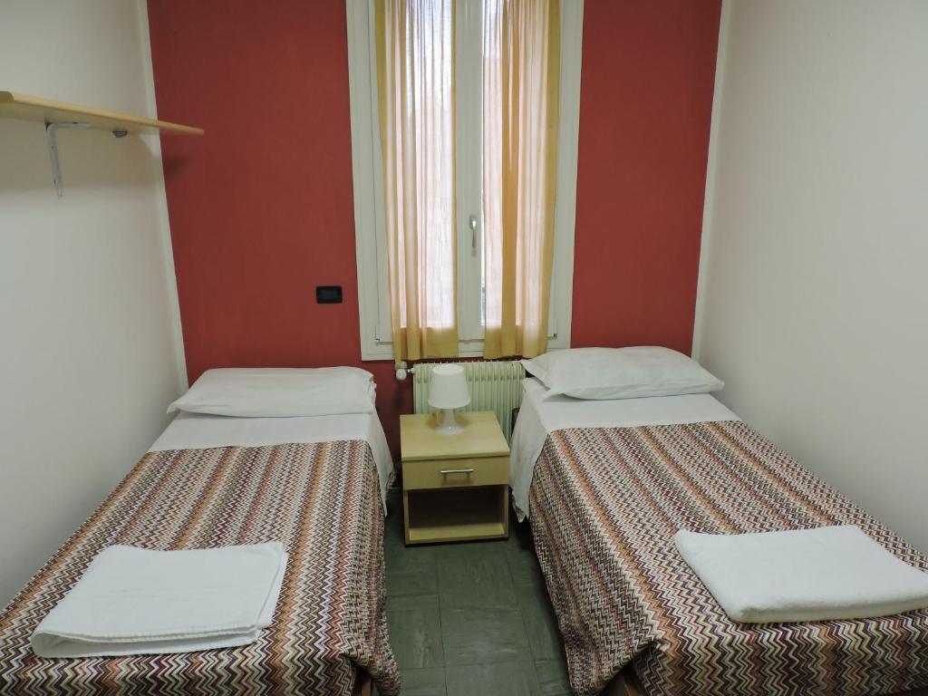 Letto o letti in una camera di Ostello Bassano Del Grappa