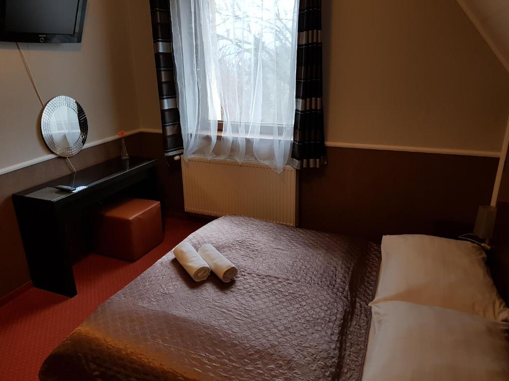Postel nebo postele na pokoji v ubytování Amaretto Szállás