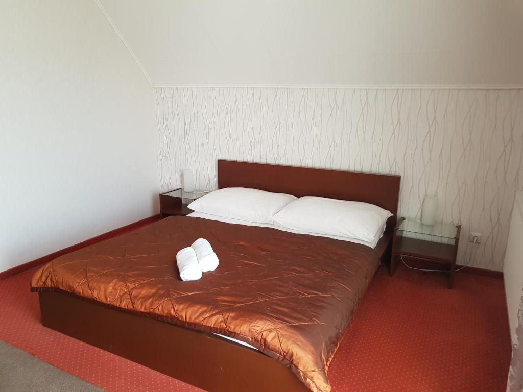 Postel nebo postele na pokoji v ubytování Amaretto Szállás