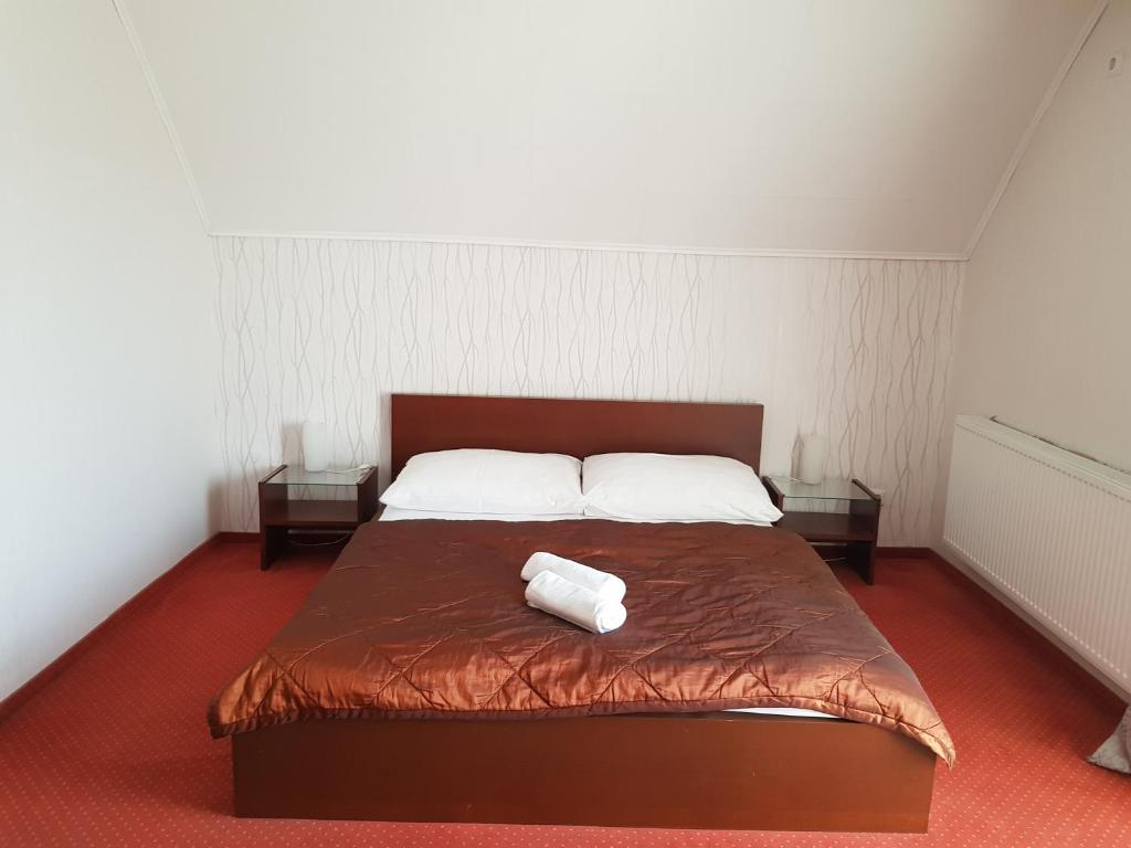 Postel nebo postele na pokoji v ubytování Amaretto Szállás
