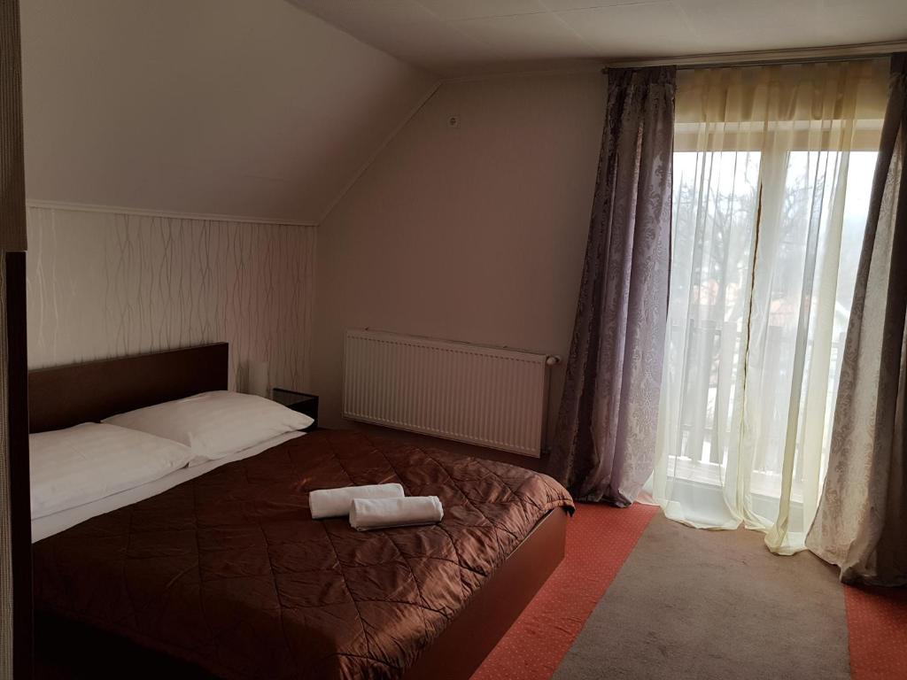 Postel nebo postele na pokoji v ubytování Amaretto Szállás