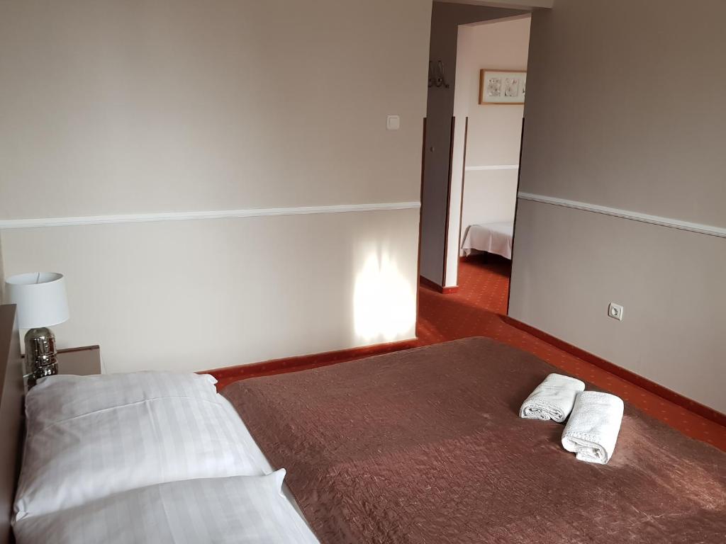 Postel nebo postele na pokoji v ubytování Amaretto Szállás