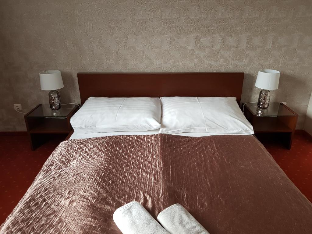 Postel nebo postele na pokoji v ubytování Amaretto Szállás