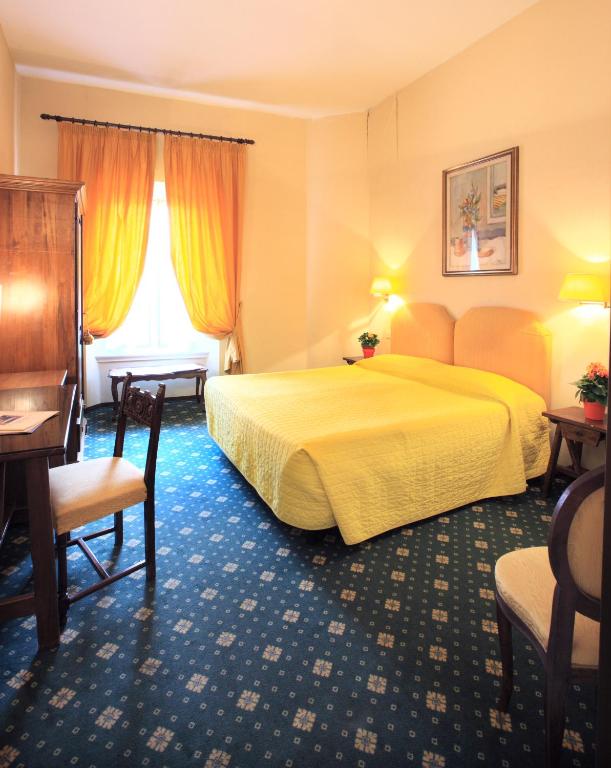 A bed or beds in a room at Hotel S.Giorgio & Olimpic