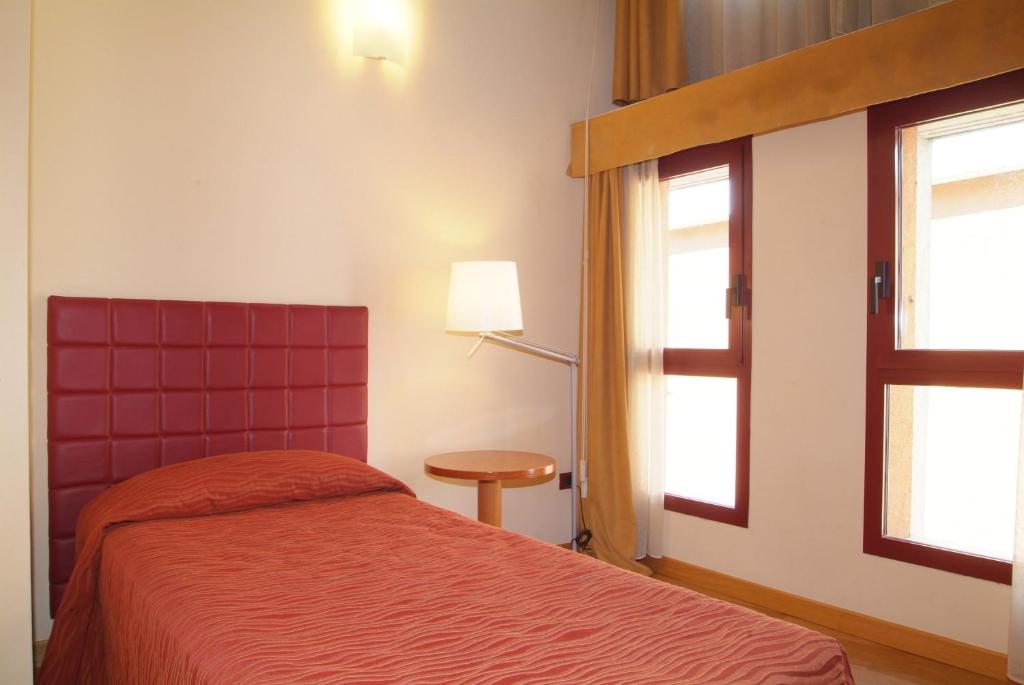 Postel nebo postele na pokoji v ubytování Hotel Maxim