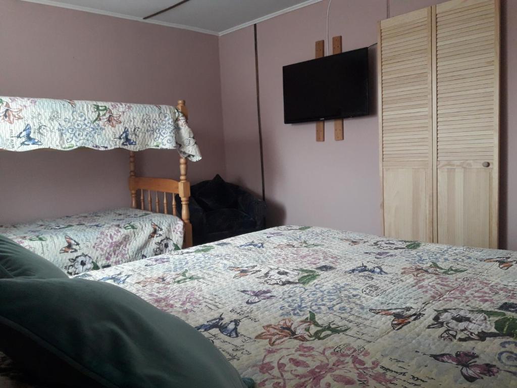 Postel nebo postele na pokoji v ubytování Hostal Torres del Paine 2