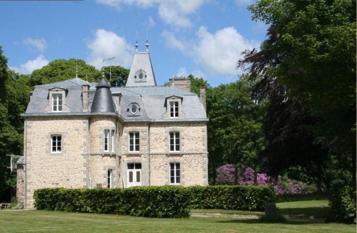 an old stone house with a tower on top of it at Au Château in La Lucerne-dʼOutremer