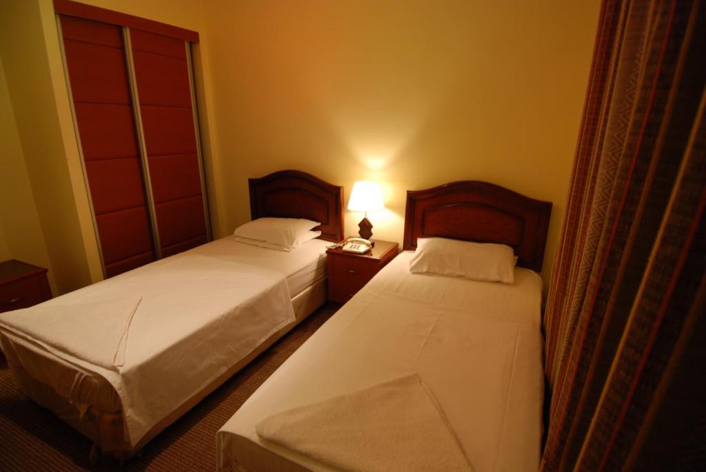Postel nebo postele na pokoji v ubytování Al Rashid Hotel