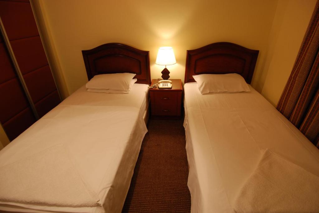 Postel nebo postele na pokoji v ubytování Al Rashid Hotel