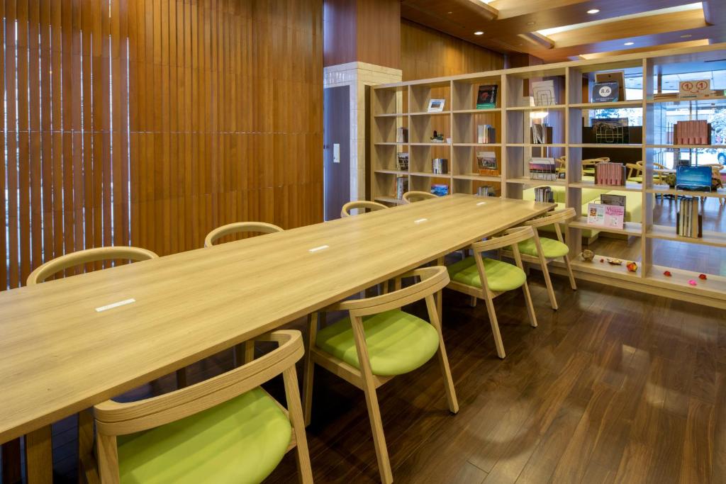 a room filled with tables and chairs at Chisun Grand Nagano in Nagano