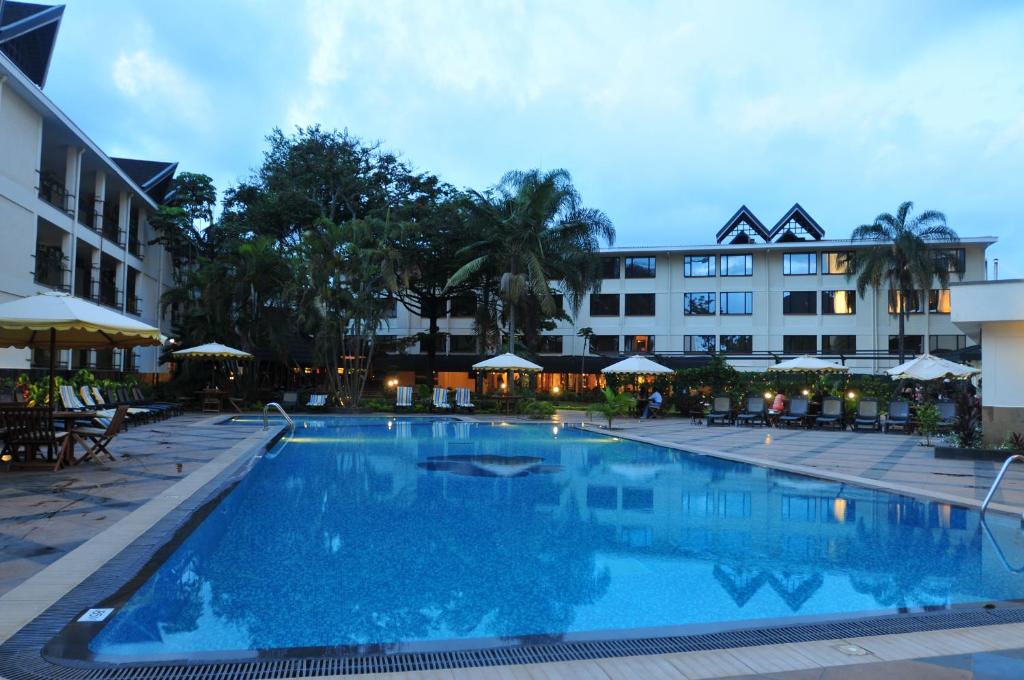 a large swimming pool in front of a hotel at Jacaranda Hotel Nairobi in Nairobi