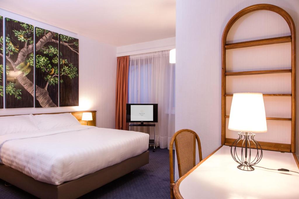 Postel nebo postele na pokoji v ubytování Hotel Sagitta