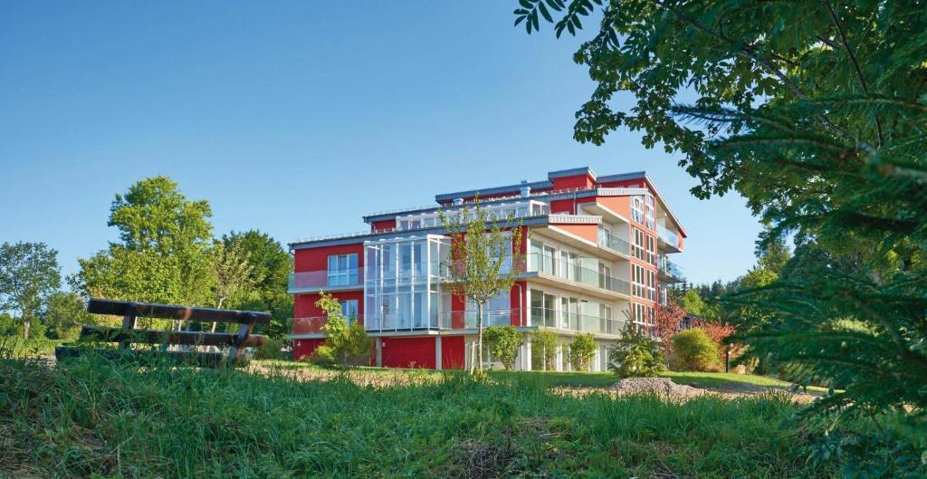 a red building in the middle of a park at Schwarzwald Lodge Rothaus in Grafenhausen