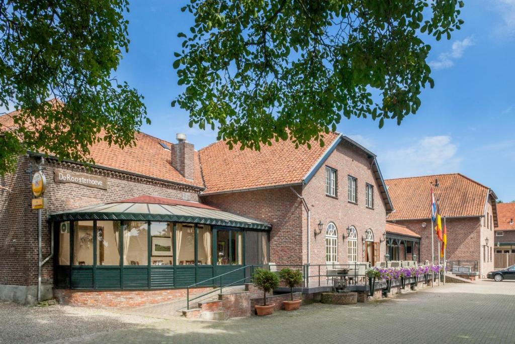 a brick building with a store front at Hotel Restaurant De Roosterhoeve in Roosteren