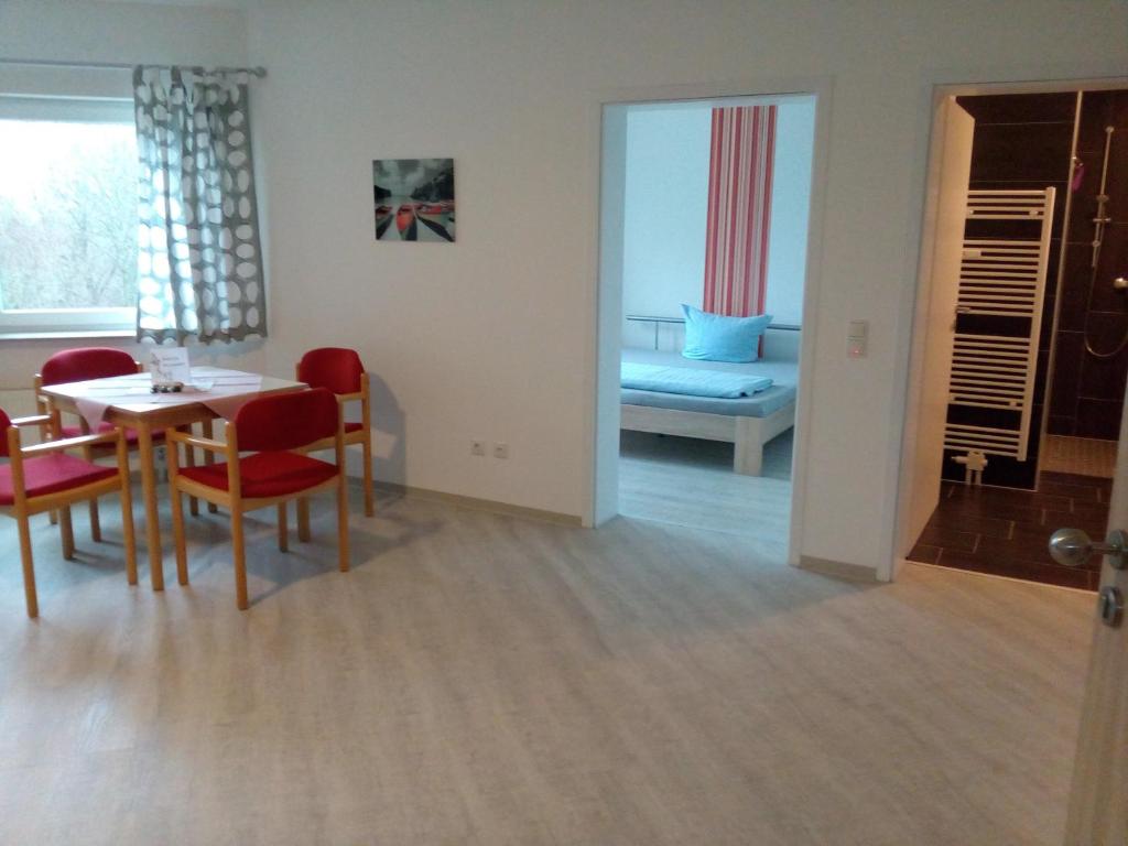 a dining room and living room with a table and chairs at Ferienwohnung im Haus "Maria Anna" in Bad Ems