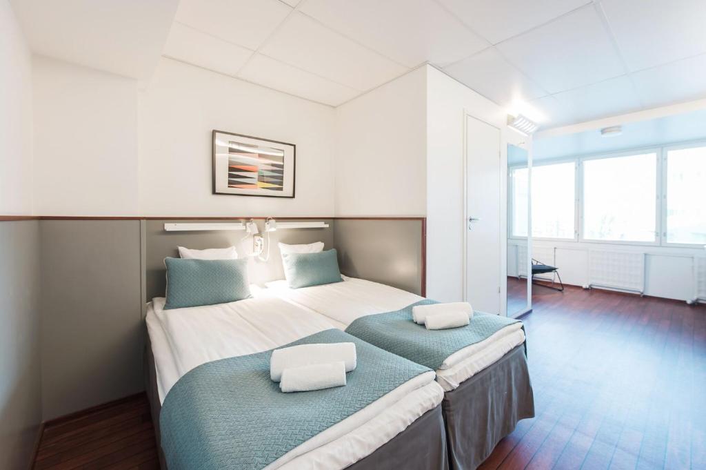 1 dormitorio con 1 cama grande y 2 almohadas en Forenom Aparthotel Helsinki Kamppi - contactless check-in, en Helsinki