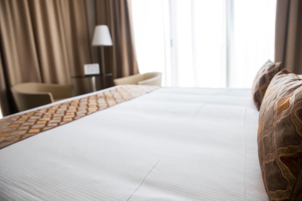 Posteľ alebo postele v izbe v ubytovaní Hotel Datini
