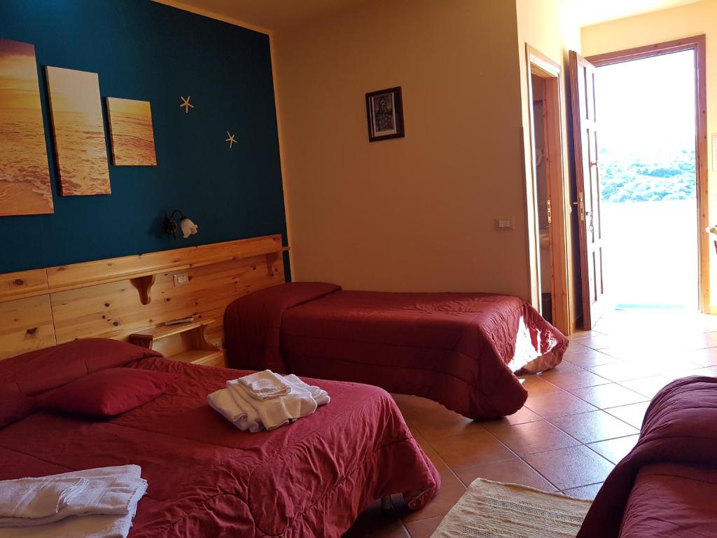 Postel nebo postele na pokoji v ubytování Hotel Il Cortile
