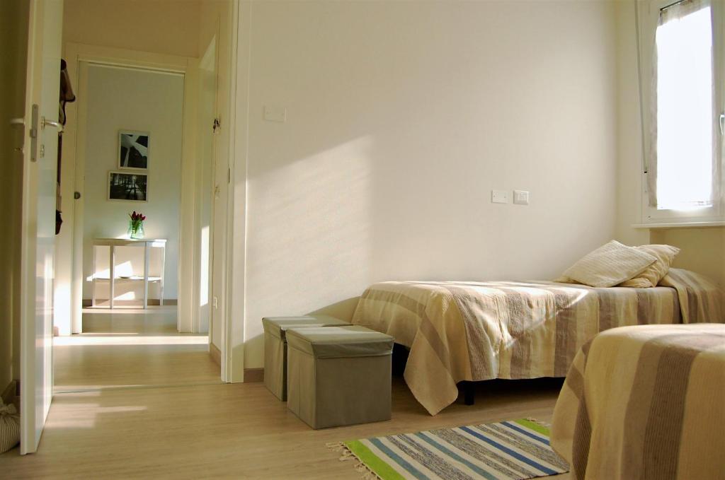 A bed or beds in a room at Gardaselle Holiday Rooms