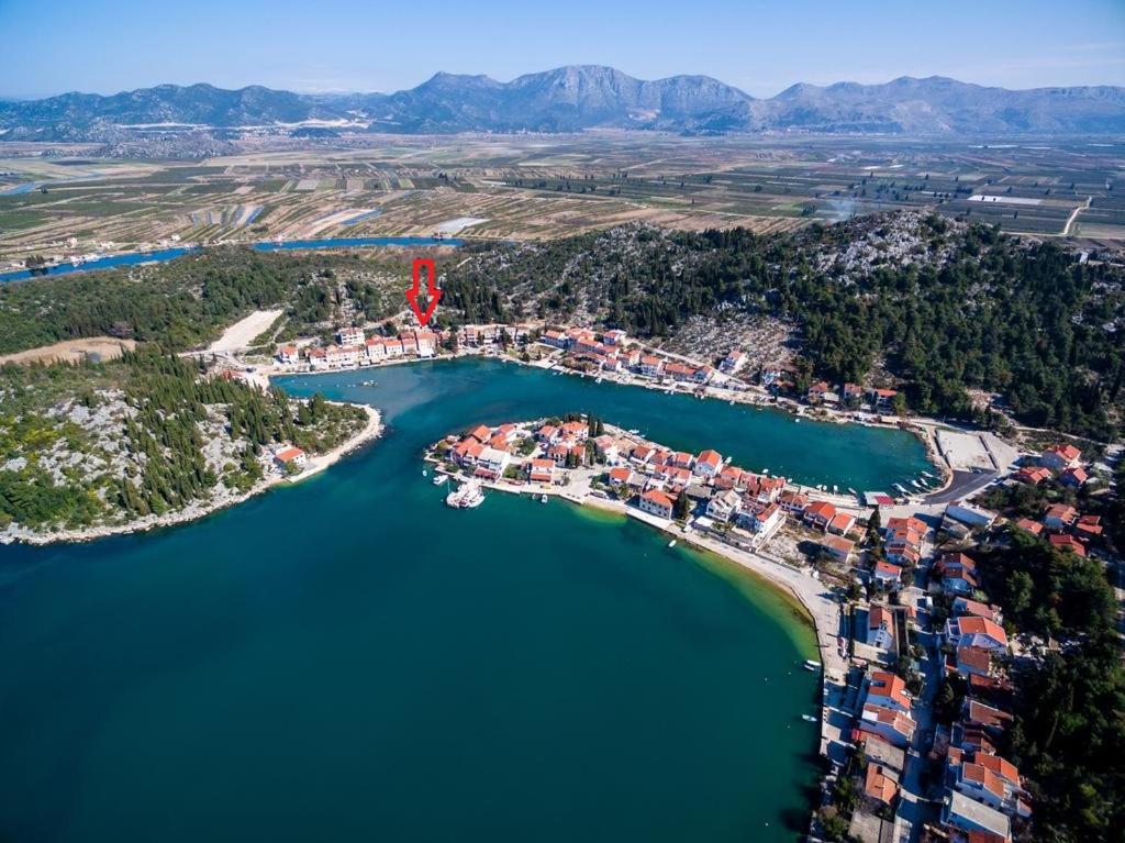 an aerial view of a small island in a lake at Ivan i Matej Apartments in Blace