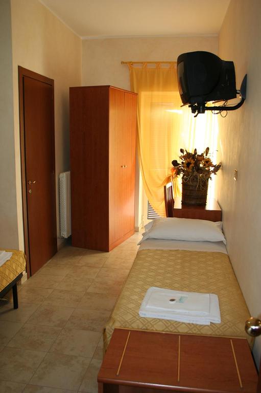 Postel nebo postele na pokoji v ubytování Hotel Casarola - Trigoria