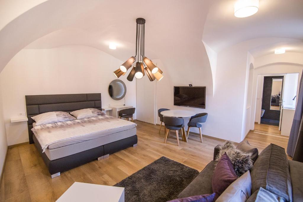 a bedroom with a bed and a living room at St. Marks Apartment 1 in Zagreb