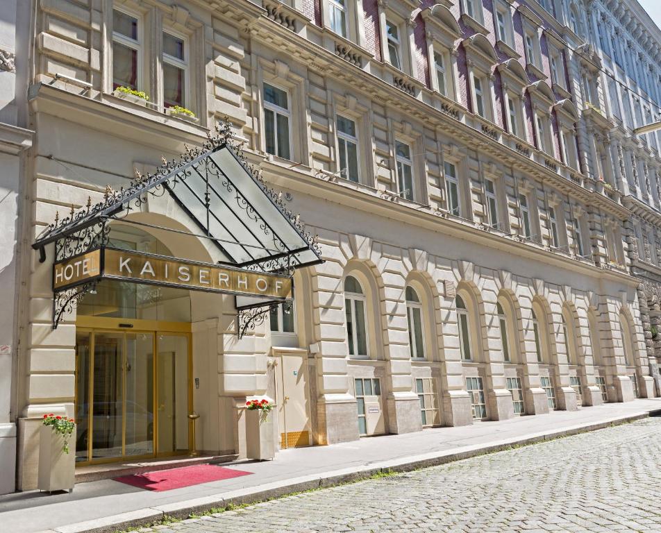 a building with a sign on the side of it at Hotel Kaiserhof Wien in Vienna