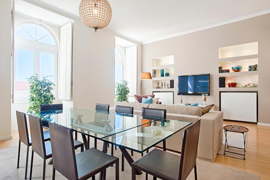 a living room with a glass table and chairs at Libest Chiado 3 - Largo do Picadeiro in Lisbon