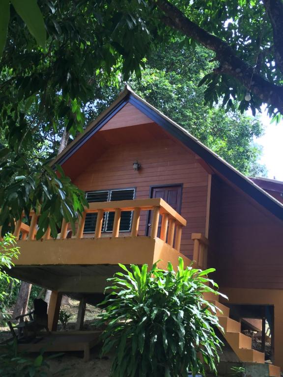 a house with a large deck on the side of it at Banhalawee in Ko Yao Yai