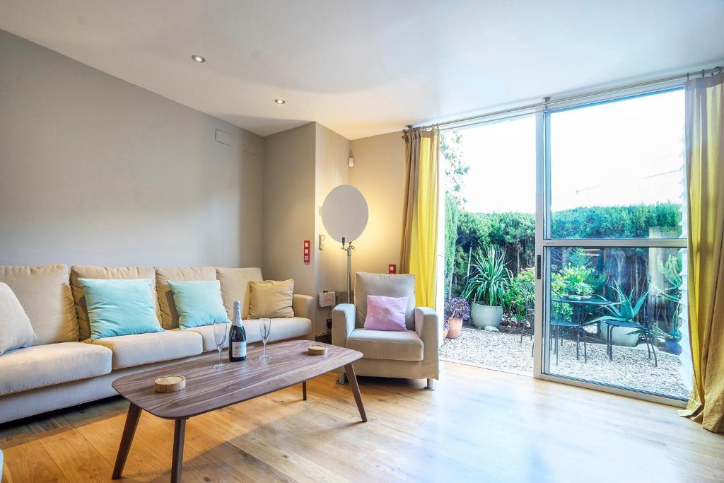 a living room with a couch and a table at Friendly Rentals Olimpic Beach in Barcelona