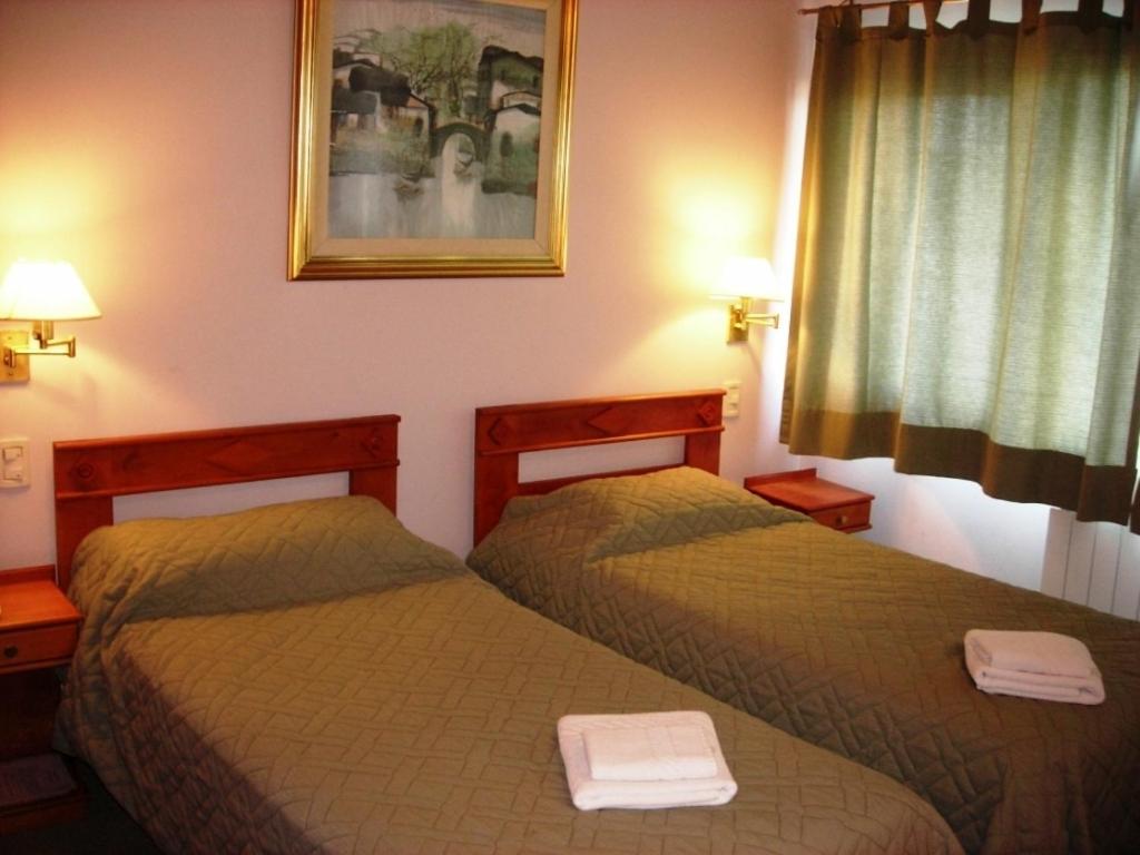 Кровать или кровати в номере Hotel Antartida Argentina