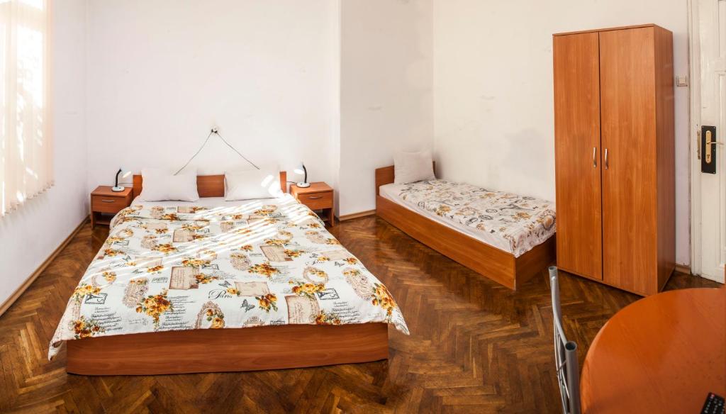 A bed or beds in a room at Central GuestHouse Five Corners