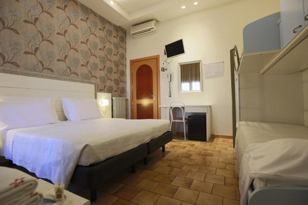 Postel nebo postele na pokoji v ubytování ELISABETTA hotel