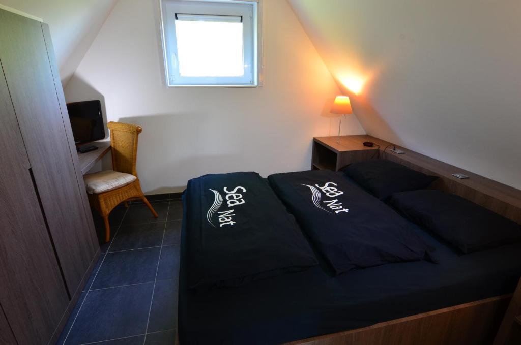 Voodi või voodid majutusasutuse B&B wellness Sea Nat voor Naturisten toas
