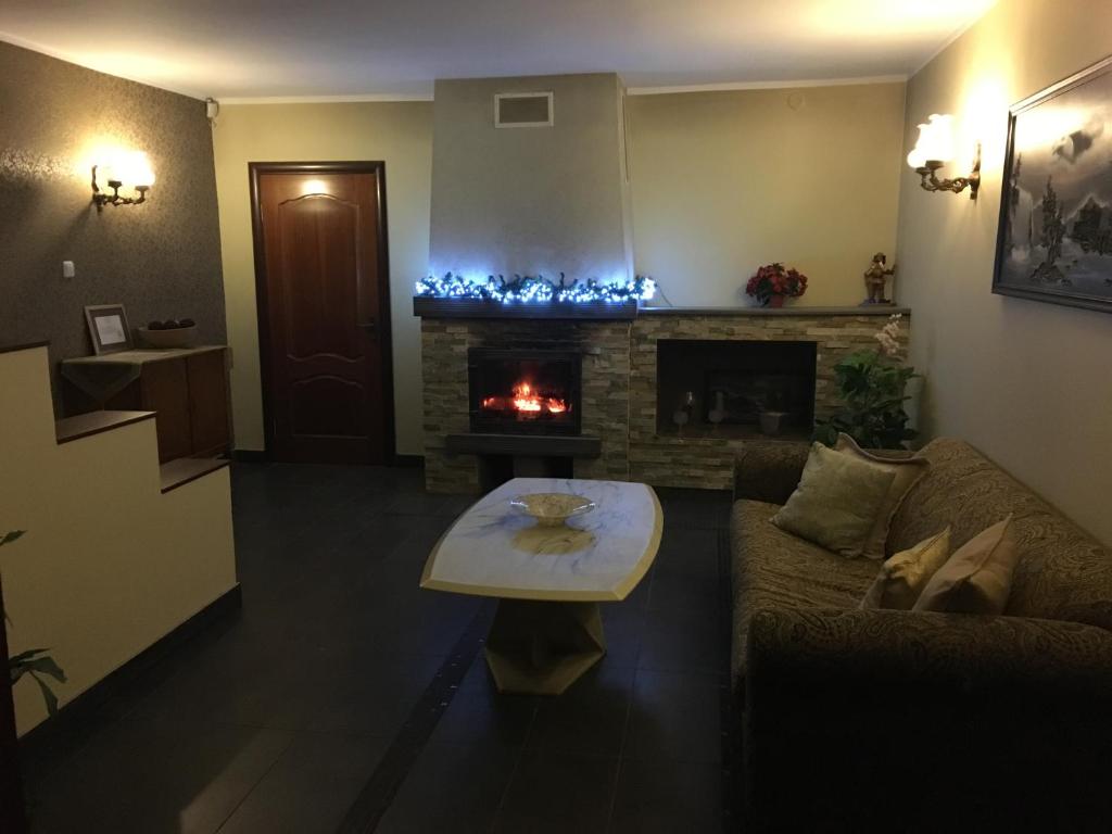 a living room with a couch and a fireplace at Lee Apartments in Tallinn