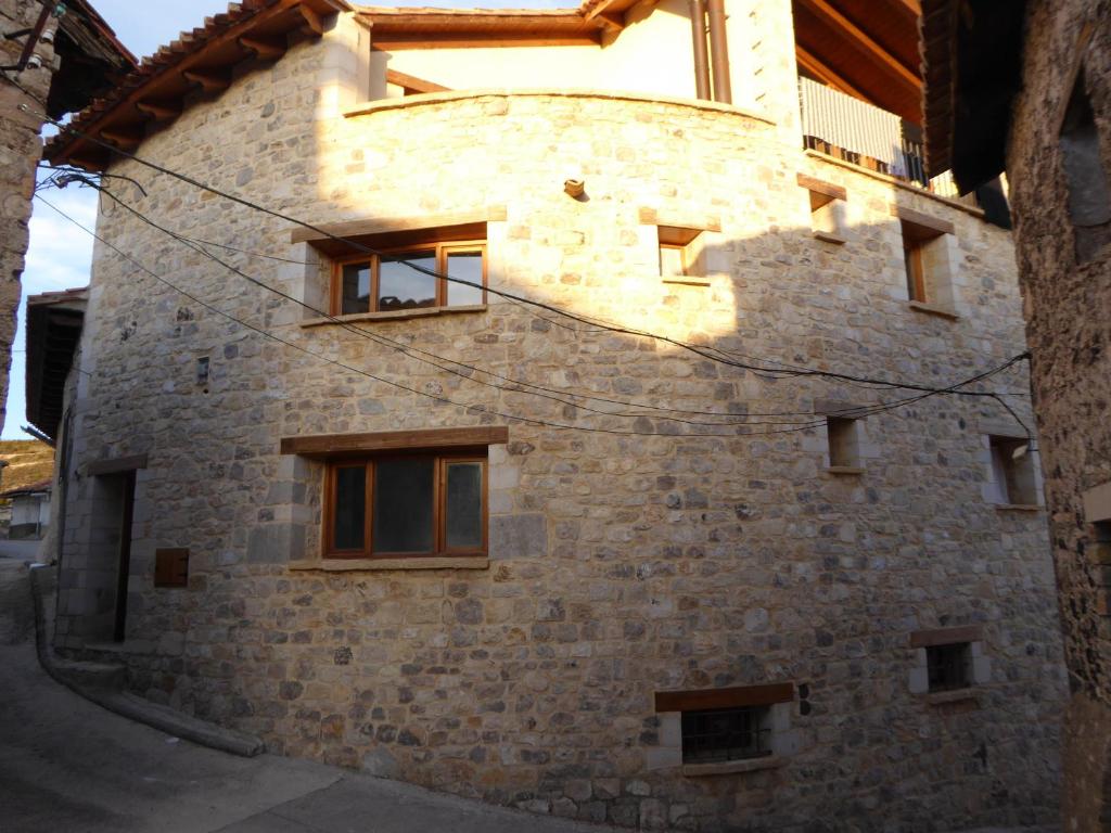 a stone building with windows on the side of it at Casa rural La Sabina in Fortanete