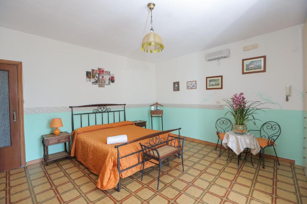 a bedroom with a bed and two chairs in it at Villa Marietta in Minori