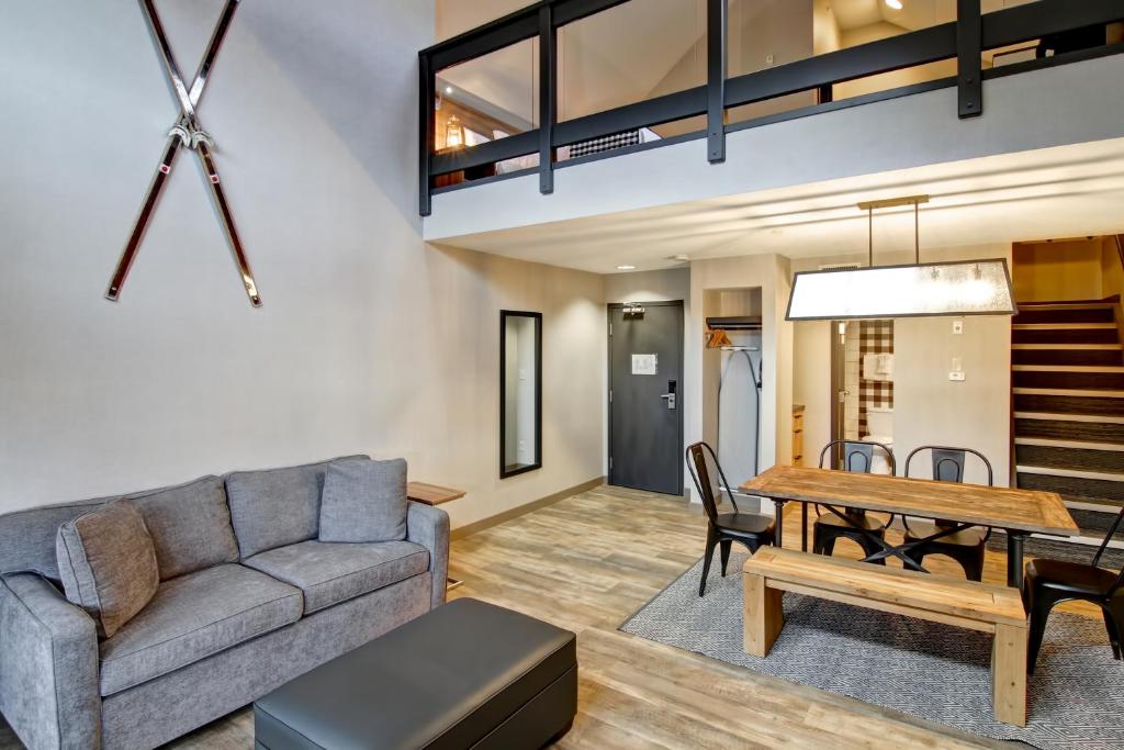 a living room with a couch and a table at Canalta Lodge in Banff