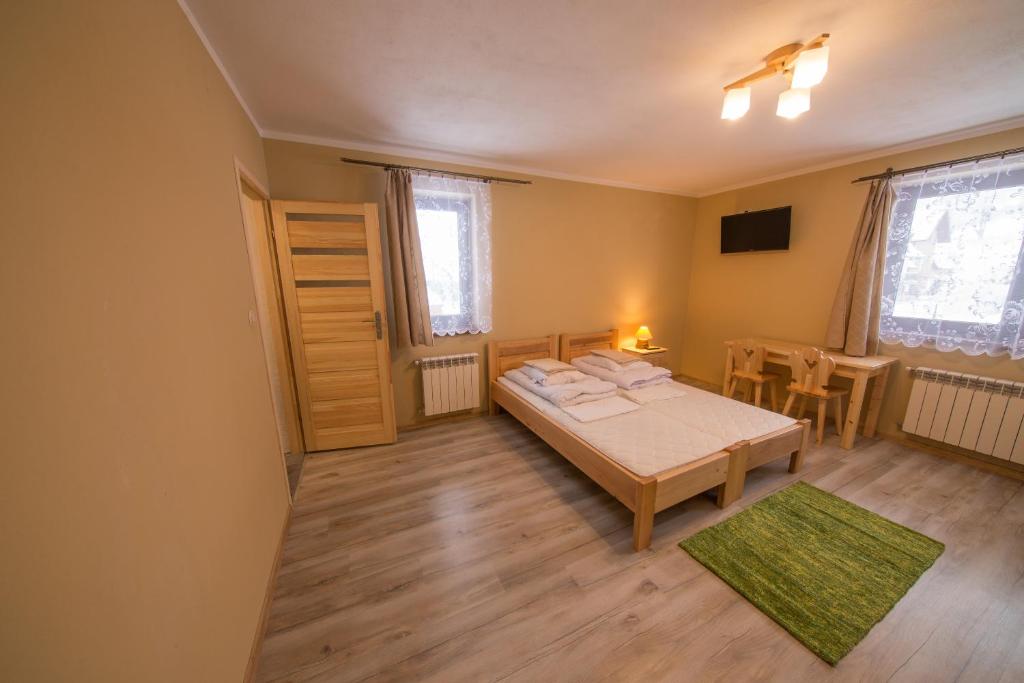Posteľ alebo postele v izbe v ubytovaní Pokoje i Apartamenty Nad Potokiem