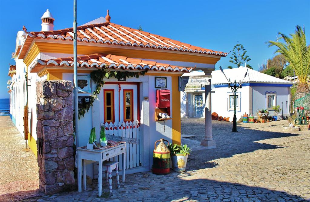 a small house on the side of a street at Villa Ana Margarida Beach in Ericeira