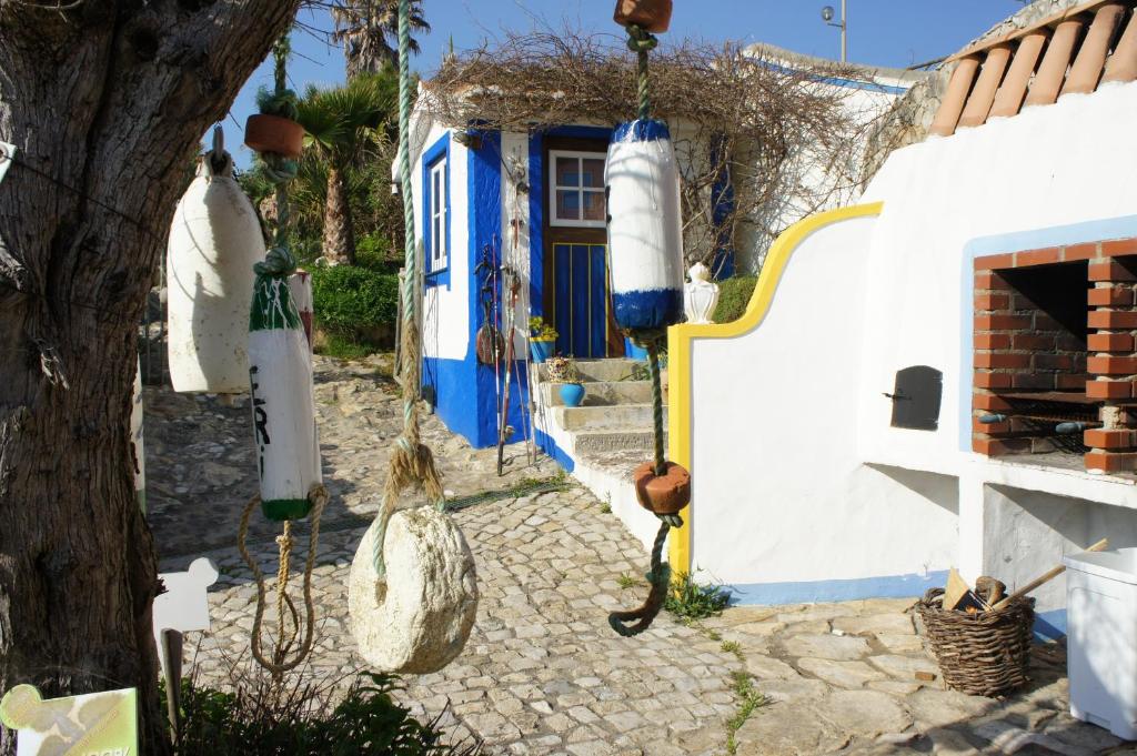 a blue and white house with a blue door at Villa Ana Margarida Beach in Ericeira